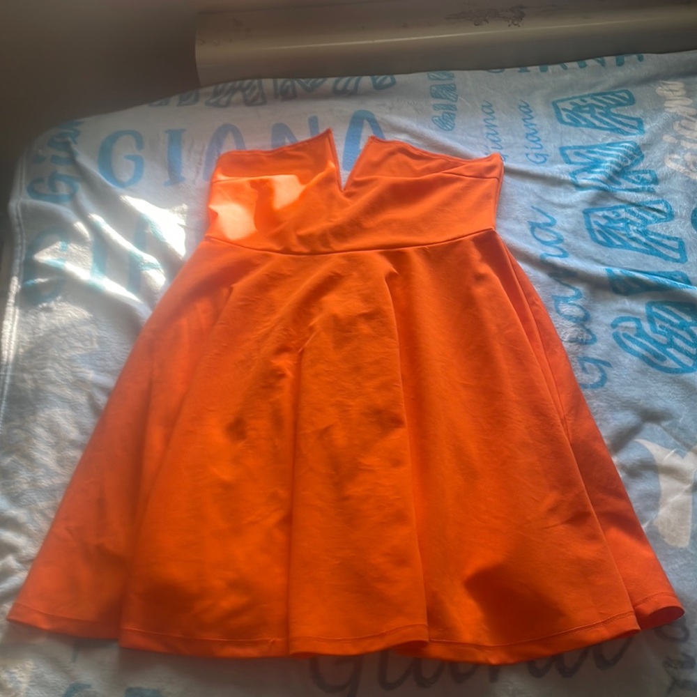 A orange strapless dress size medium V shape in the middle